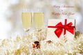 Merry Christmas. Champagne in two glasses and red gift box celebrating and party Christmas at home. Royalty Free Stock Photo