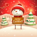 Merry Christmas! Cheerful snowman holds wooden board sign in Christmas snow scene winter landscape. Royalty Free Stock Photo