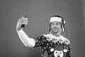 merry christmas. cheerful unshaven man in santa hat and sweater making selfie on phone. man celebrate xmas party. winter Royalty Free Stock Photo