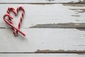 Merry Christmas. Christmas card. Christmas candy canes, heart shape, wooden background. New Year mockup.