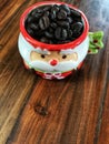 Merry Christmas,coffee beans in Cute Santa Claus Cup Royalty Free Stock Photo