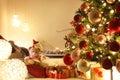 Merry christmas, comfortable living room with lighted tree, decorations and gift packages