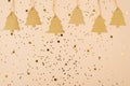 Merry Christmas composition concept. Close up view flatlay photo of cute trees label on string on shiny confetti golden beige