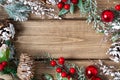 Merry Christmas composition. Fir branches with cones, berries and snow decorations on old dark wooden background with copy space Royalty Free Stock Photo