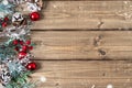 Merry Christmas composition. Fir branches with cones, berries and snow decorations on old dark wooden background with copy space Royalty Free Stock Photo