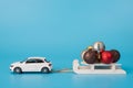 Merry Christmas concept. Photo of side view modern car carrying sledges with leap of different colorful tree decor isolated over