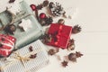 merry christmas concept. presents with ornaments pine cones anise and car toy on rustic white wooden background top view, space f Royalty Free Stock Photo