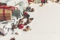 merry christmas concept. presents with ornaments pine cones anise and lights on rustic white wooden background top view, space Royalty Free Stock Photo