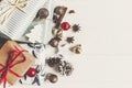 merry christmas concept. presents with ornaments pine cones anise and lights on rustic white wooden background top view, space Royalty Free Stock Photo