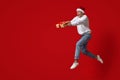 Merry Christmas. Crazy Ecxited Guy Wearing Santa Hat Jumping With Gift Box