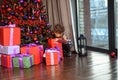 Merry Christmas! Cute little child girl is decorating the Christmas tree Royalty Free Stock Photo