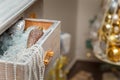 Merry Christmas decorated interior details. Drawer with shiny pine cone toy, pearl beads, artificial snow. Golden baubles,