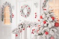 Merry christmas decoration on white house home porch with wreath on door and Xmas tree with red toys and window with warm Royalty Free Stock Photo