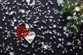 Merry Christmas decorations, snowflakes, white red hearts and green xmas tree on black wooden background card, top view Royalty Free Stock Photo