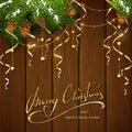 Merry Christmas with decorations and streamers on brown wooden