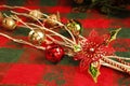 CHRISTMAS decorations,  white branches, jingle bells, red metal poinsettia flower Royalty Free Stock Photo