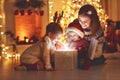 Merry Christmas! family mother and children with magic gift at