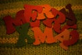 Merry Christmas felt letters on knitted background