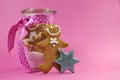 Merry Christmas festive gingerbread men in glass cookie jar with copy space