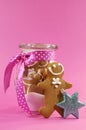 Merry Christmas festive gingerbread men in glass cookie jar - vertical