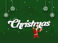 Merry Christmas Font with Cartoon Santa Claus Holding Gift Box, Jingle Bell and Hanging Baubles on Green Royalty Free Stock Photo