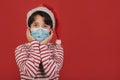Merry Christmas,funny kid with medical mask wearing Santa Claus hat Royalty Free Stock Photo