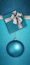 Merry christmas gift card , blue box and silver shiny ribbon bow, xmas ball on turquoise glittering background, top view copy Royalty Free Stock Photo