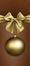 Merry christmas gift card with golden satin sparkling ribbon bow and xmas ball on brown glittering background, copy space layout Royalty Free Stock Photo