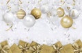 Merry Christmas gift greeting card, with decorated golden hanging balls and gift box, background with bright ribbons and glitter Royalty Free Stock Photo