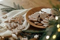 Merry Christmas! Gingerbread cookies with icing in plate on wooden rustic table with fir branches, festive decorations and Royalty Free Stock Photo