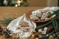 Merry Christmas! Gingerbread cookies with icing in plate on wooden rustic table with fir branches, festive decorations and Royalty Free Stock Photo