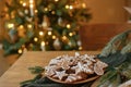 Merry Christmas! Gingerbread cookies with icing in plate on wooden table with fir branches and festive decorations against Royalty Free Stock Photo