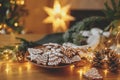 Merry Christmas! Gingerbread cookies with icing in plate on wooden table with fir branches and festive decorations against Royalty Free Stock Photo