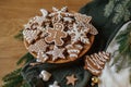 Merry Christmas! Gingerbread cookies with icing in plate on wooden table flat lay with fir branches and festive decorations. Royalty Free Stock Photo