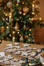 Merry Christmas! Gingerbread cookies with icing on wooden table with fir branches and festive decorations on background of Royalty Free Stock Photo
