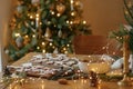 Merry Christmas! Gingerbread cookies with icing on wooden table with fir branches and festive decorations on background of Royalty Free Stock Photo