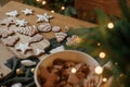 Merry Christmas! Gingerbread cookies with icing on wooden table with fir branches and festive decorations on background of Royalty Free Stock Photo