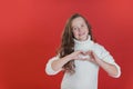 Merry Christmas girl in white sweater on bright red vivid color background Royalty Free Stock Photo