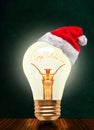 Merry Christmas Glowing Light Bulb With Santa Hat And Copy Space Royalty Free Stock Photo