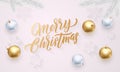 Merry Christmas golden calligraphy lettering, Xmas gold and silver balls on snowflakes pattern. Vector Xmas holiday greeting card Royalty Free Stock Photo