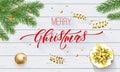 Merry Christmas golden decoration and calligraphy font on white wooden background for greeting card. Vector Christmas or New Year Royalty Free Stock Photo