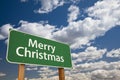 Merry Christmas Green Road Sign Over Clouds and Sky Royalty Free Stock Photo