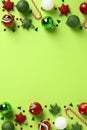 Merry Christmas green vertical background, poster, banner design. Frame made of baubles, candy canes, Xmas ornaments on green Royalty Free Stock Photo