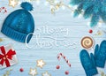 Merry Christmas Greeting Background. Winter Elements fir branches, knitted blue hat, mittens, coffee with foam, paper gift box