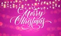 Merry Christmas greeting card calligraphy and Christmas lights garland on sparkling bokeh light background with blur effect. Vecto Royalty Free Stock Photo