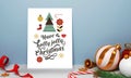 Merry Christmas Greeting Card With 3D Baubles, Golden Jingle Bell, Stars, Candy Cane, Gift Box And Curl Ribbon On Blue Royalty Free Stock Photo