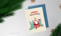 Merry Christmas Greeting Card With Rock Santa Claus, Xmas Trees And Fir Leaves On Gray