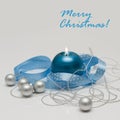 Merry Christmas greeting card template made of blue candle with blue ribbon, silver christmas balls and silver string of beads Royalty Free Stock Photo