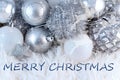 Merry christmas greeting text on silver christmas tree decorations background