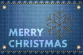 Merry Christmas greetings on blue jeans background.